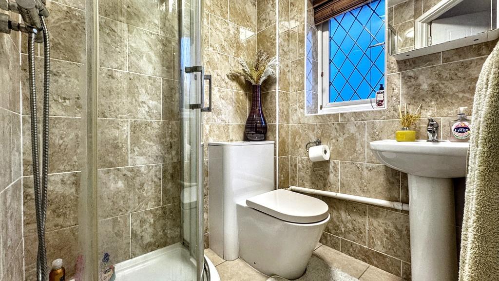 Contemporary tiled bathroom with a corner glass...