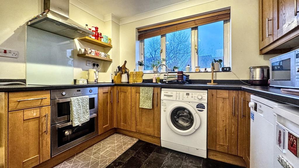 Bright, well-equipped kitchen with wooden cabin...