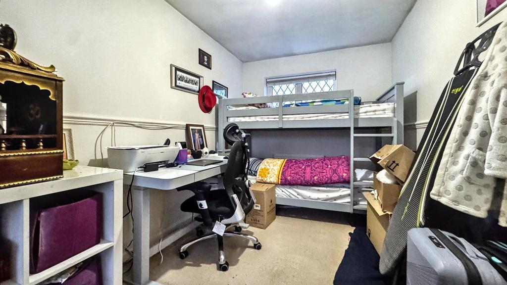 Well-organised bedroom with a bunk bed, study d...