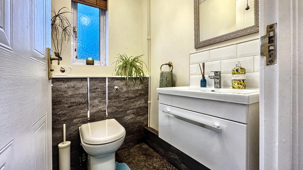 Modern downstairs bathroom with a wall-mounted ...
