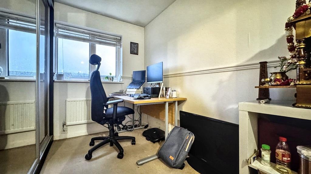 Bright, tidy workspace with a large window, erg...