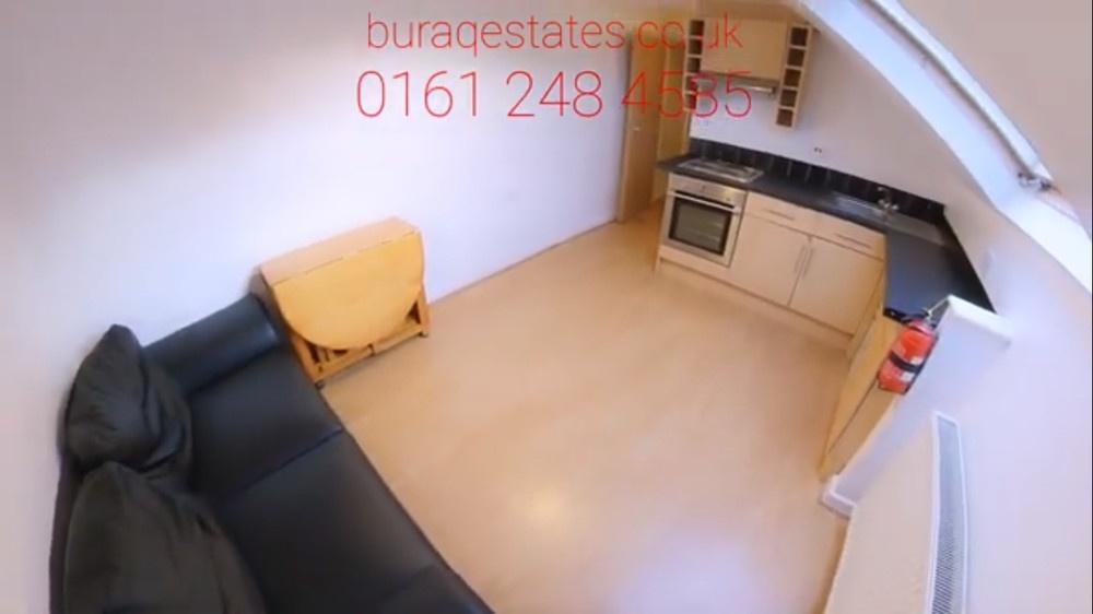 Compact open-plan living space with a fitted ki...