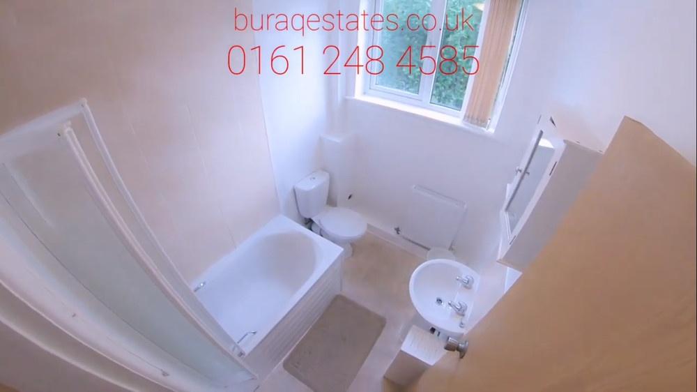 Bright, well-maintained bathroom with a bath an...