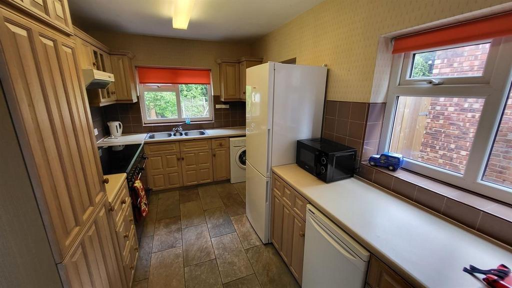 Bright, well-equipped kitchen with ample counte...