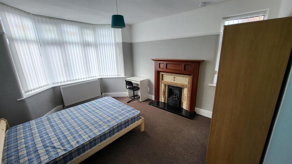 Bright double bedroom with a bay window letting...