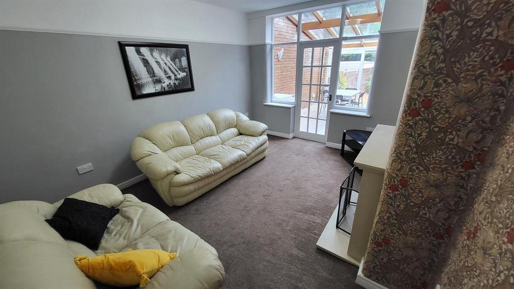 Bright, comfortable living room with light-colo...