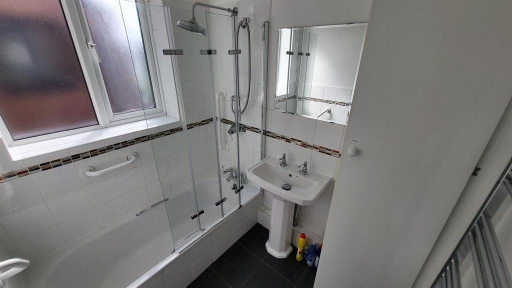 Bright modern bathroom with a combined bath and...