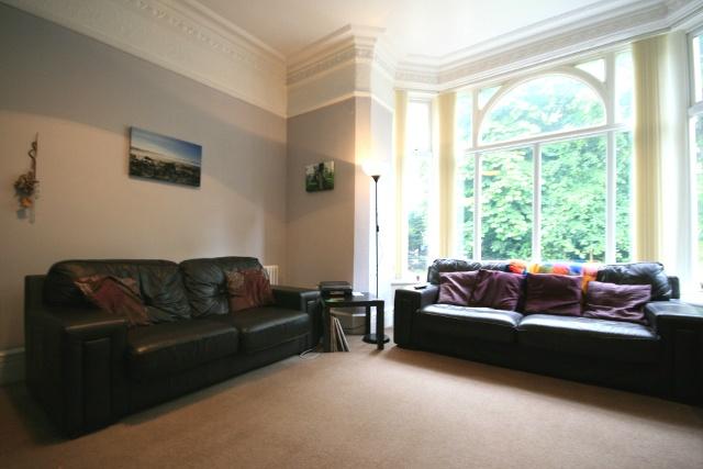 A spacious and well-lit living room featuring t...