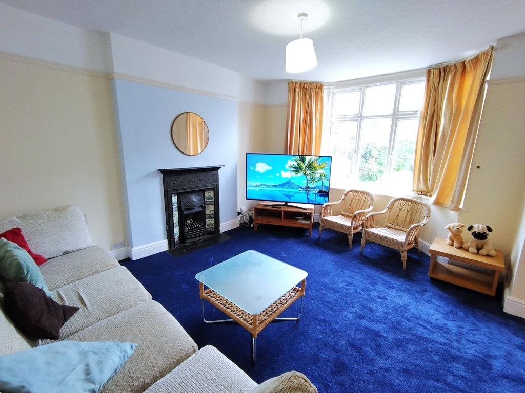 Bright, comfortable living room with a large ba...
