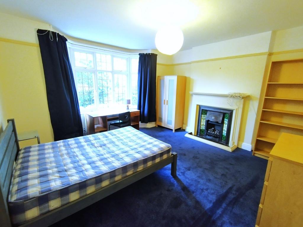 Bright, well-appointed bedroom with a large bay...