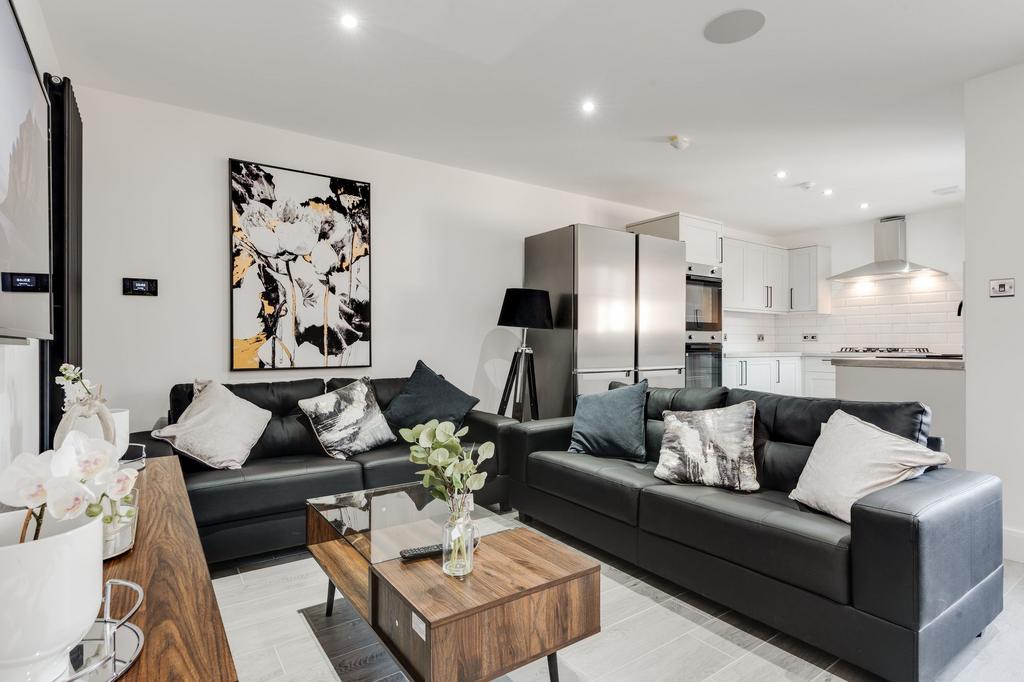A modern, bright living room featuring plush bl...