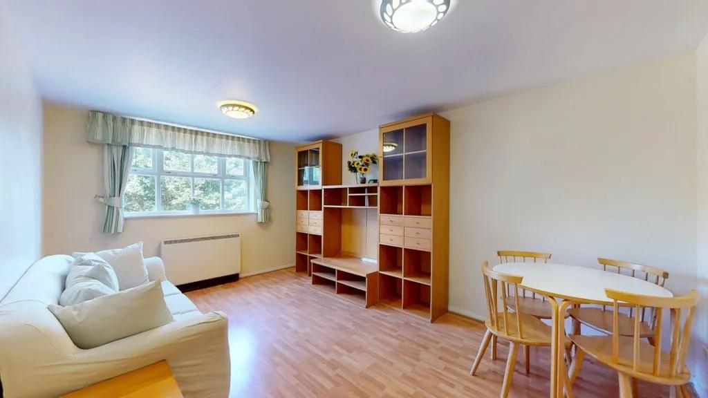 Bright, well-presented living room with a large...