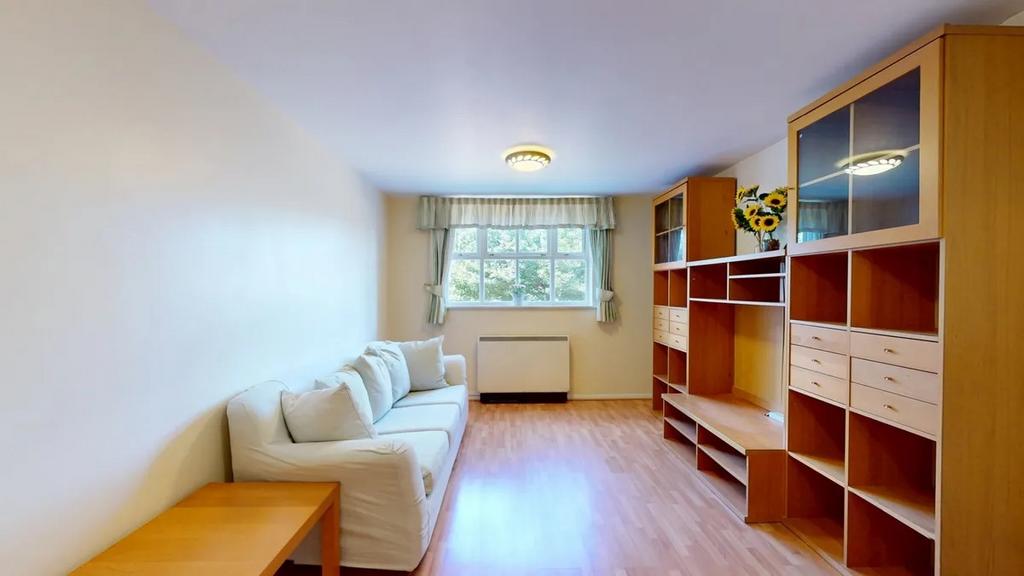 Bright, neatly presented living room with a com...