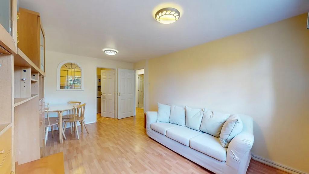 Bright, open living room with light wood floori...