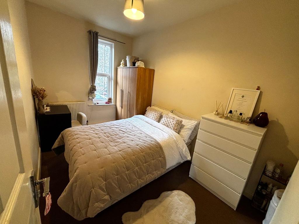 Bright, neatly presented bedroom with a comfort...