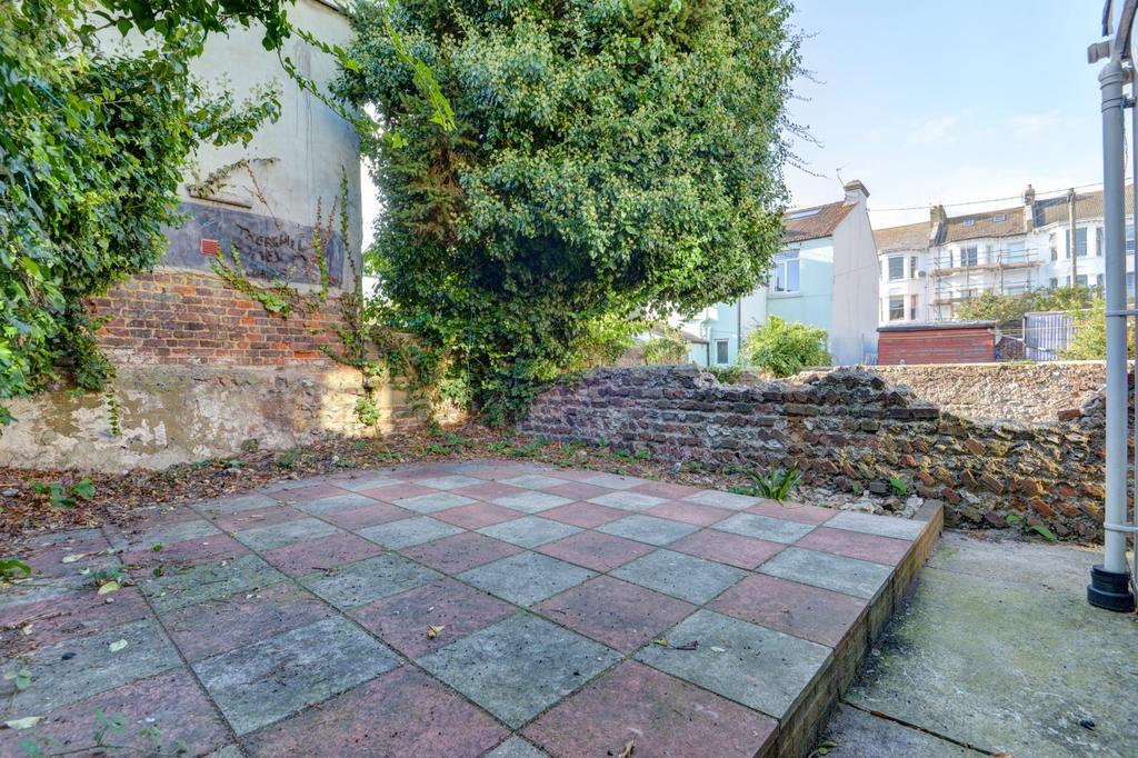Private paved courtyard with mature trees and a...