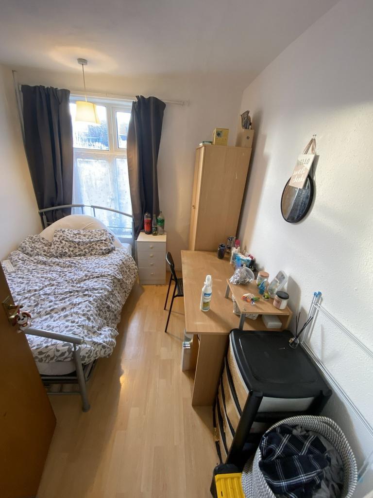 Cozy furnished bedroom with a single bed by a b...