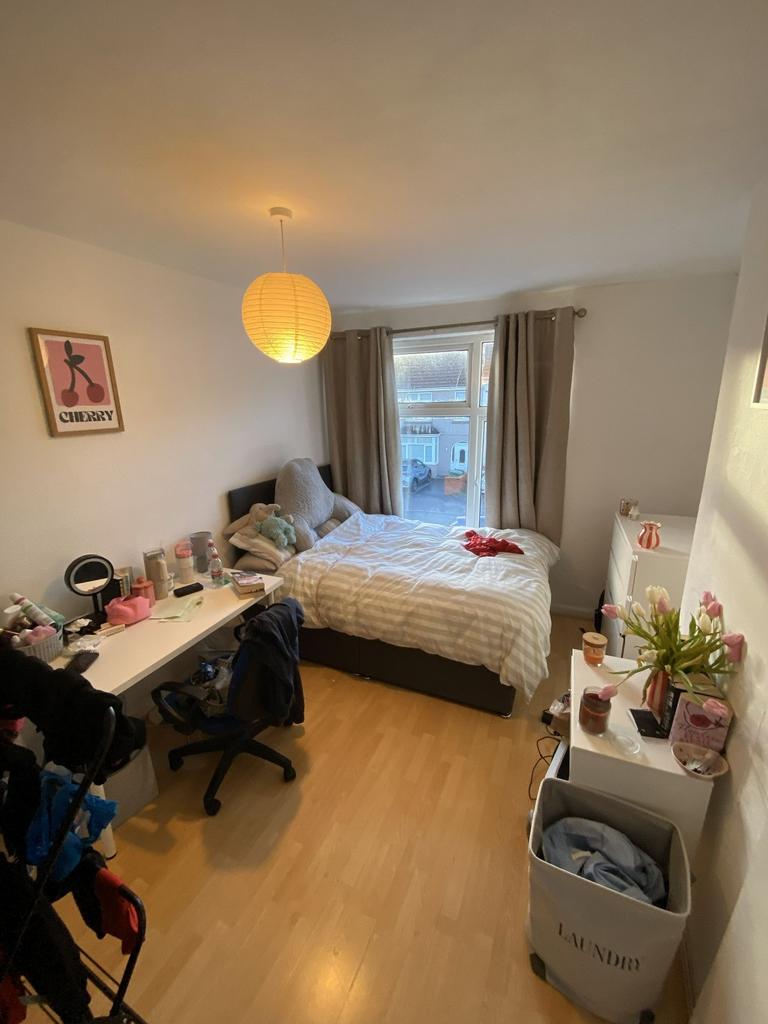 Bright, cosy bedroom with a double bed by a lar...