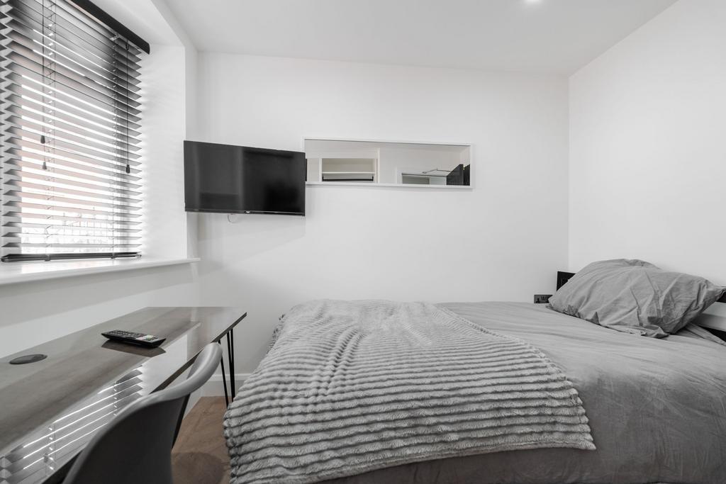 A bright and modern bedroom with a comfortable ...