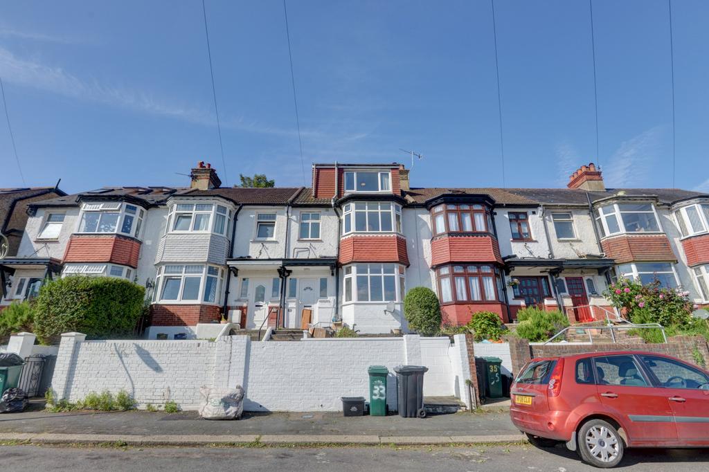 Row of bay-fronted terraced houses with well-ma...