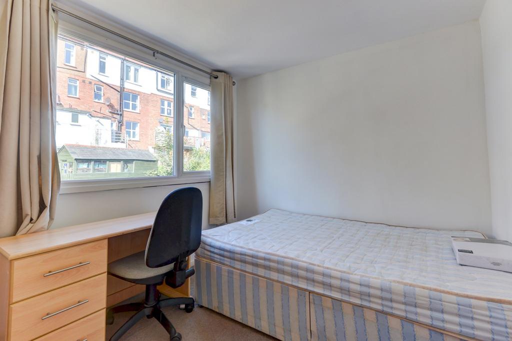 Bright, simply furnished bedroom with a large w...