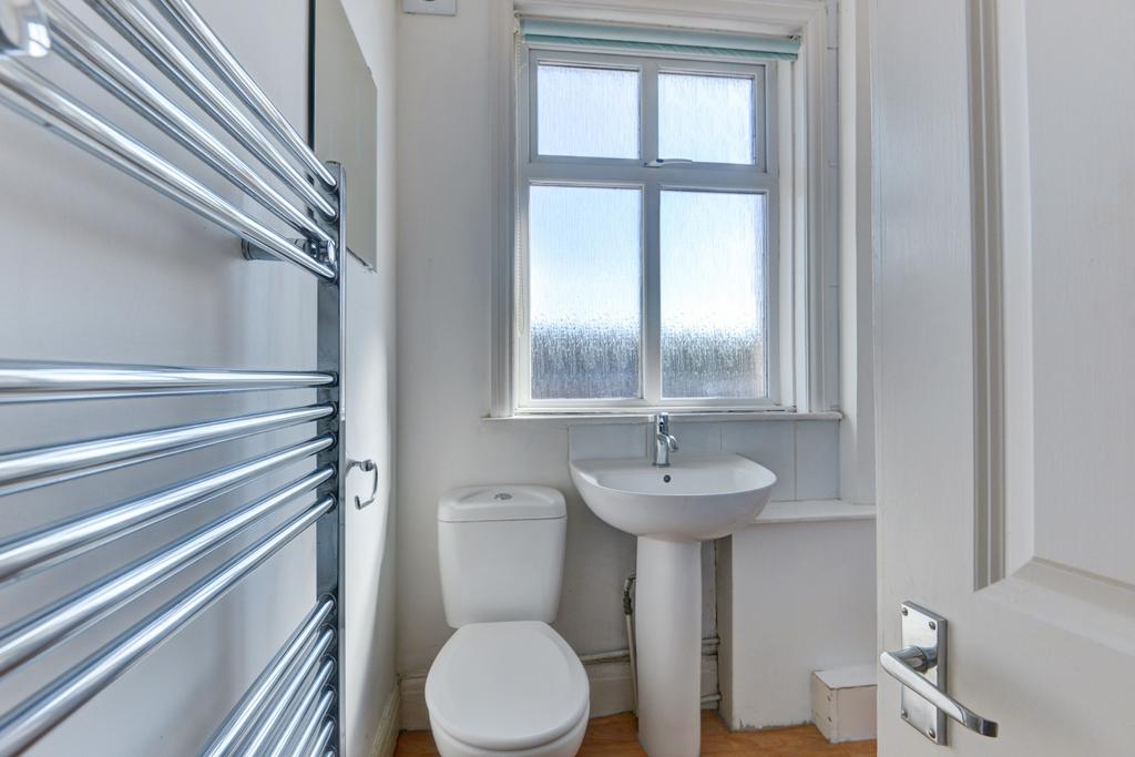 Bright, well-maintained bathroom with a pedesta...