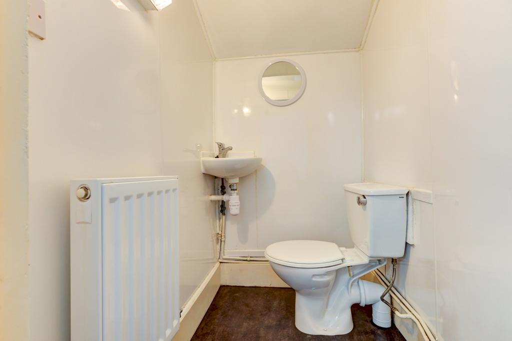 Clean, neutral WC with a compact toilet and wal...