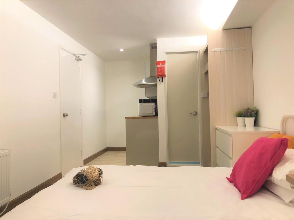 Cozy single bedroom featuring a neatly made bed...