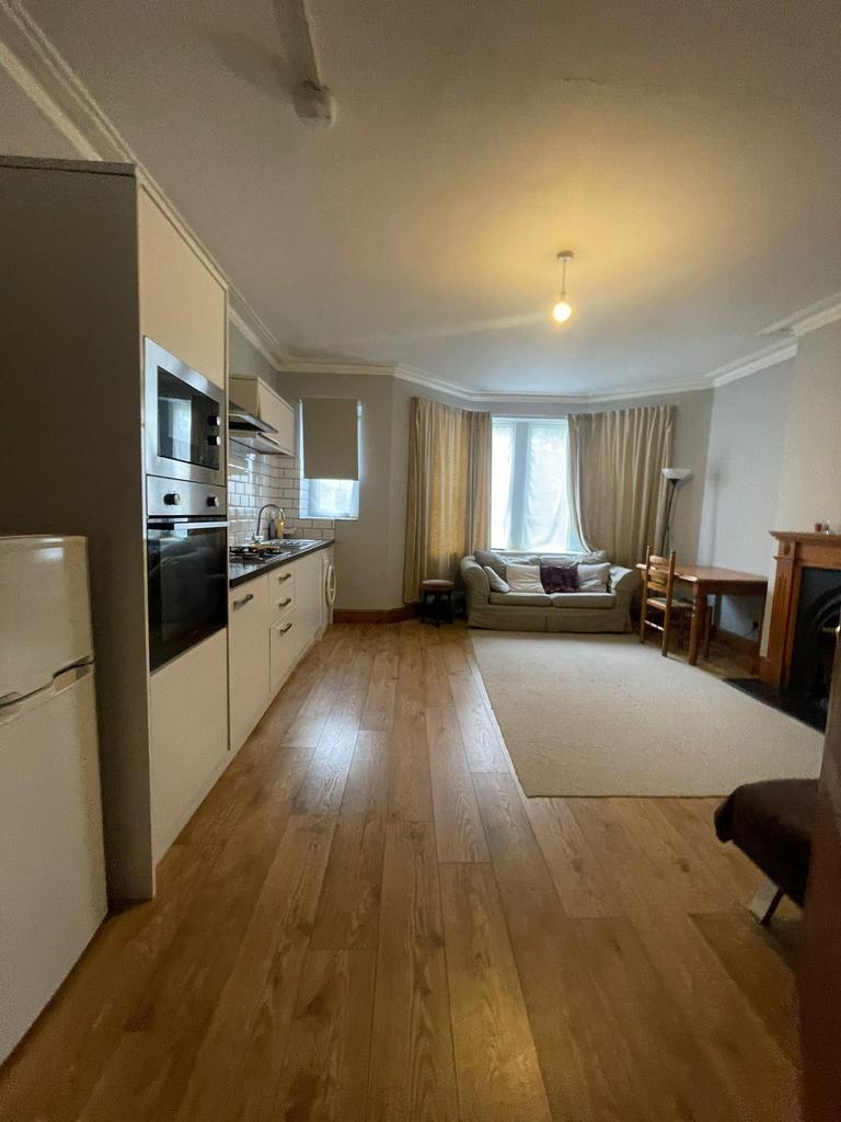 Open-plan living area with a fitted kitchen to ...
