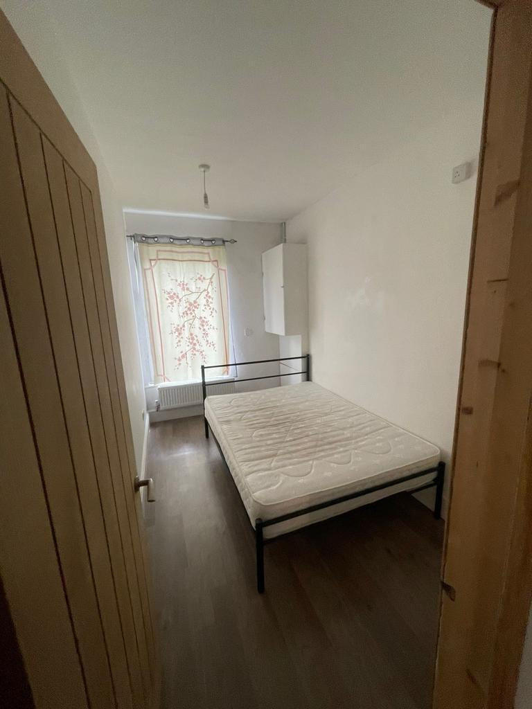 Simple double bedroom with a double metal bed f...