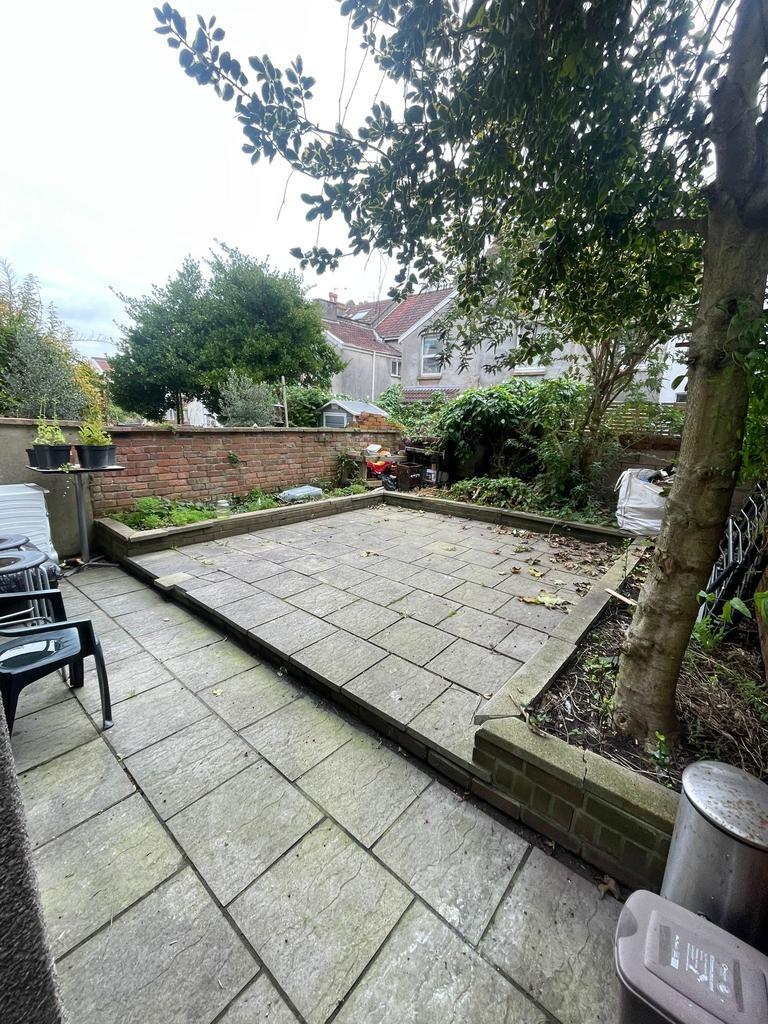 Private paved rear garden with raised planting ...