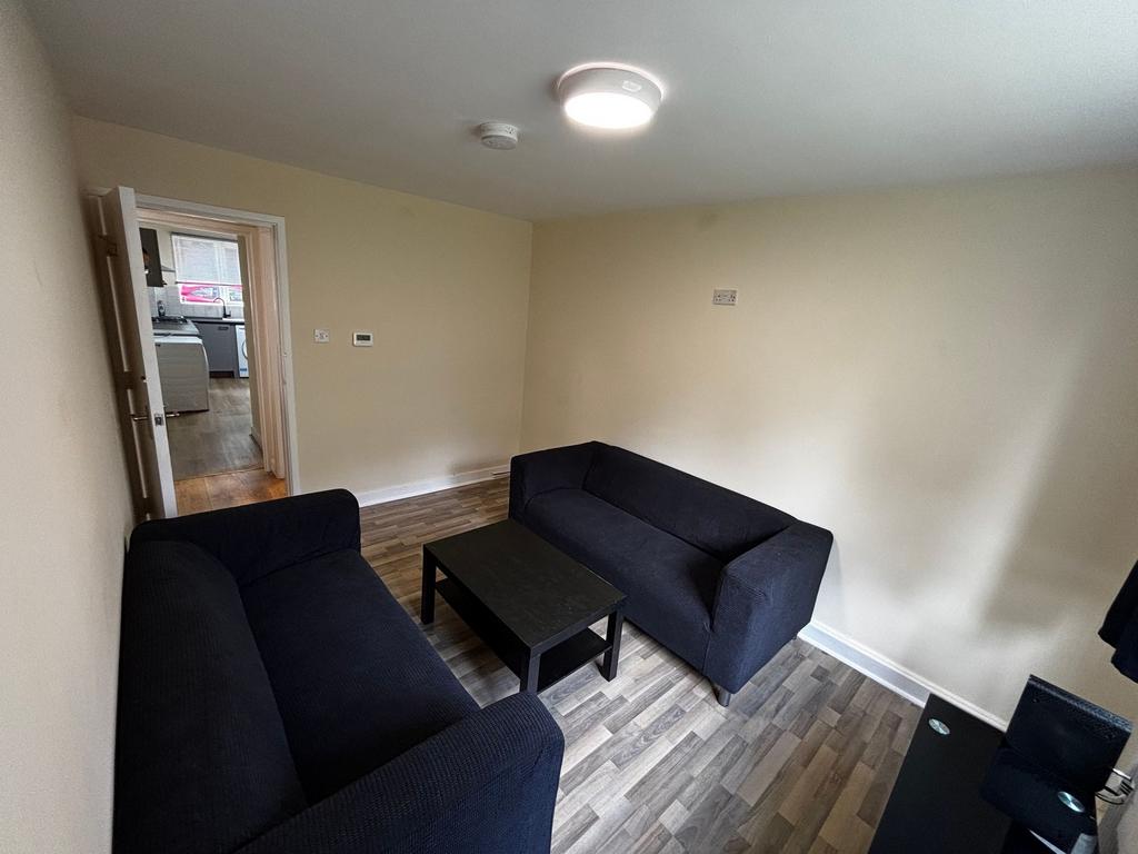 A spacious living room featuring two comfortabl...