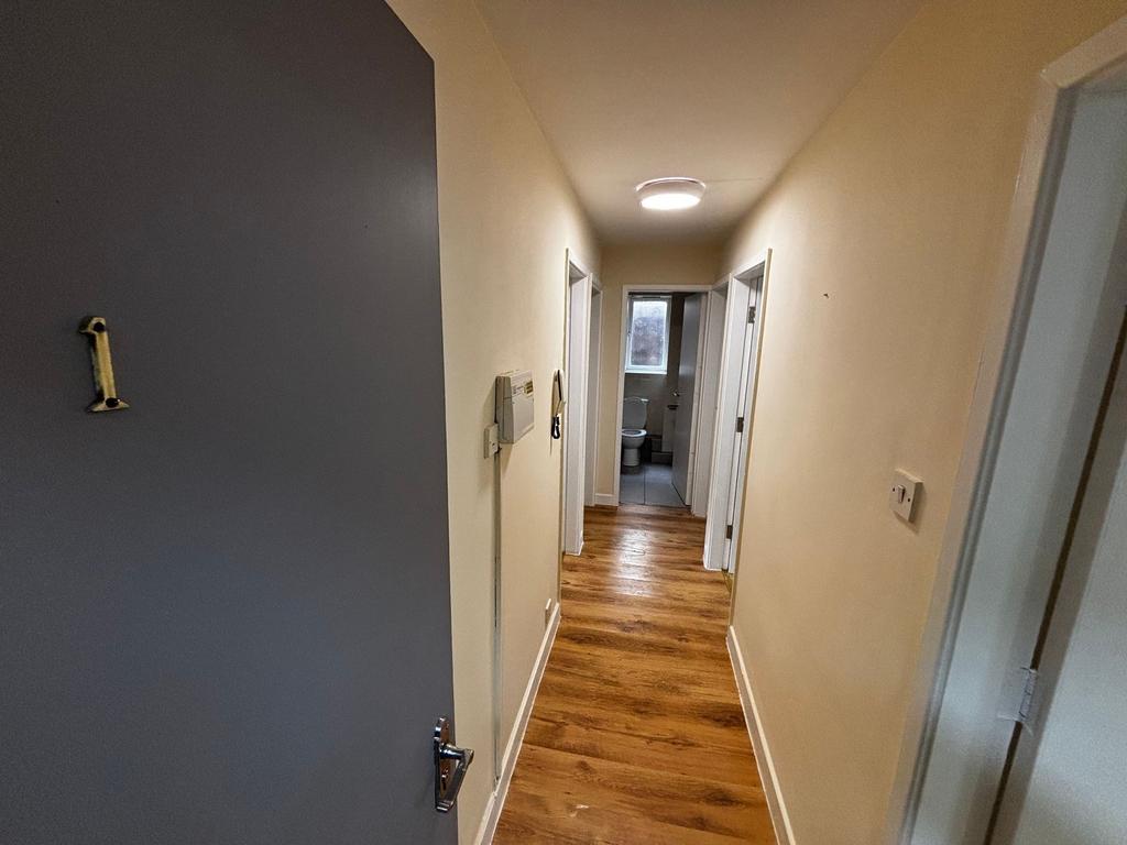 Bright and welcoming hallway with wooden floori...