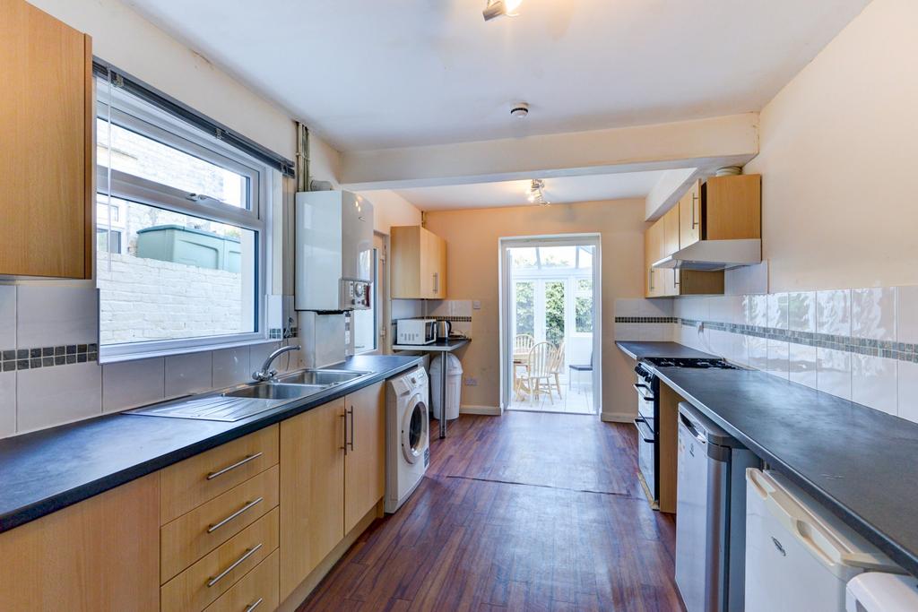 Bright galley-style kitchen with plentiful work...