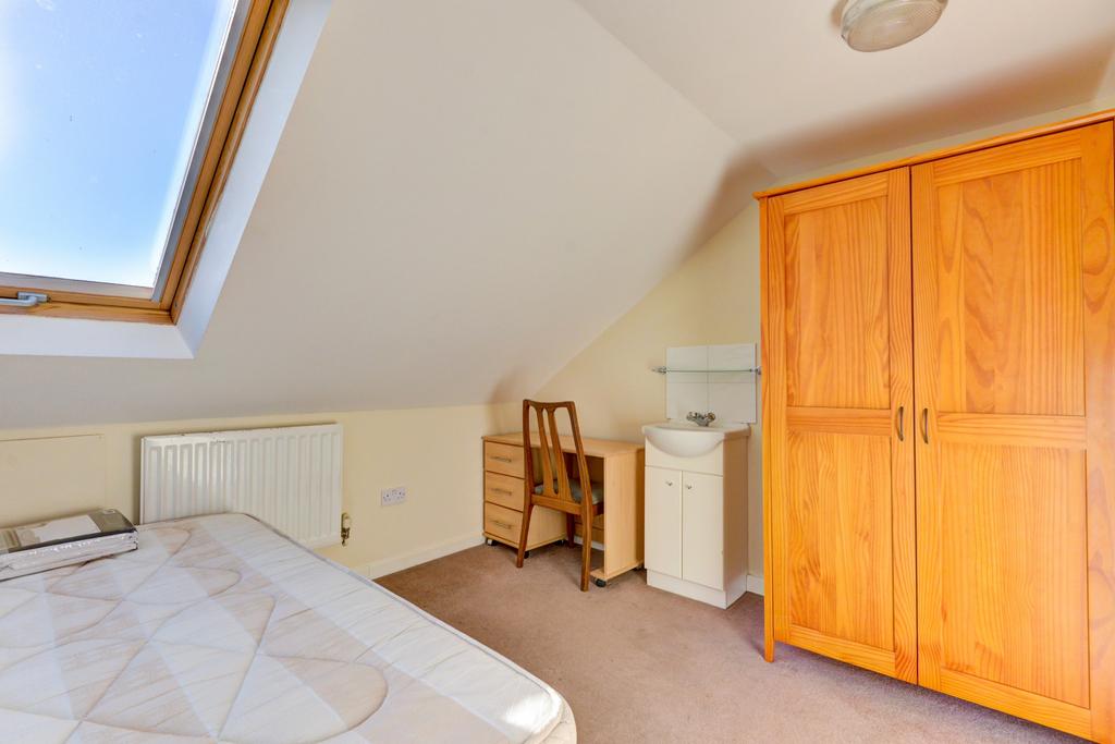 Bright attic double bedroom with a large skylig...