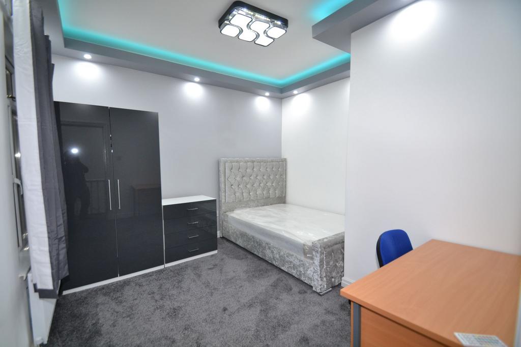 A modern, neatly maintained bedroom featuring a...