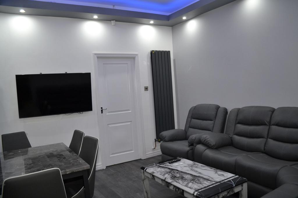 Modern living room featuring a large flat-scree...