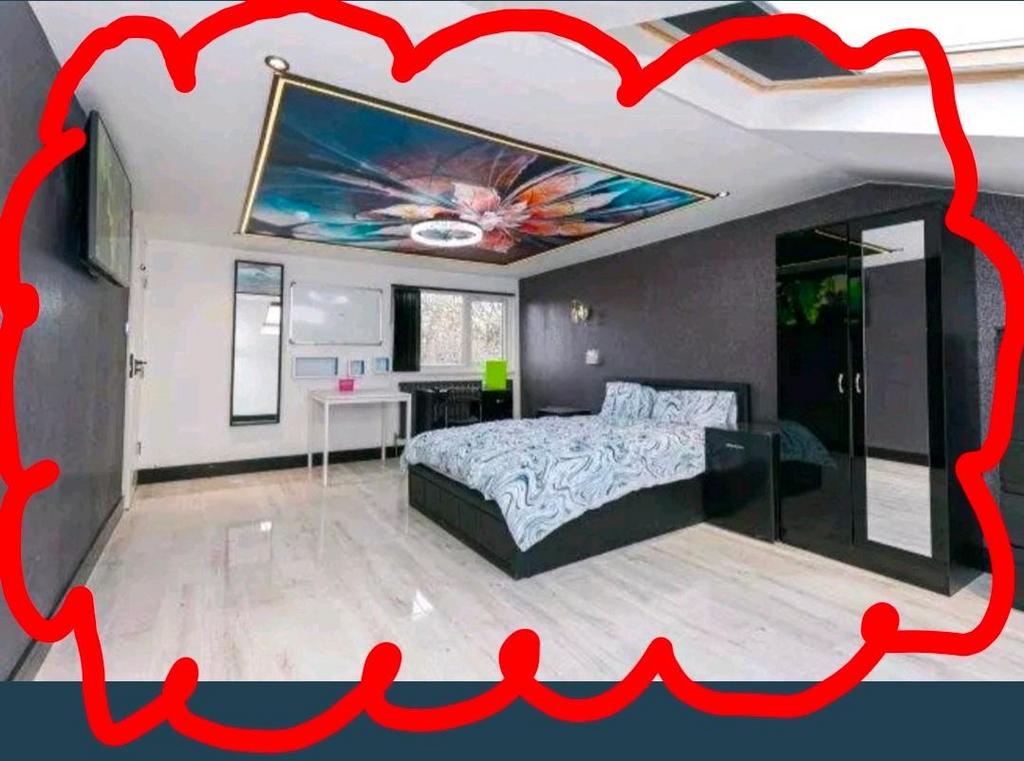 Bright, modern master bedroom with a large doub...