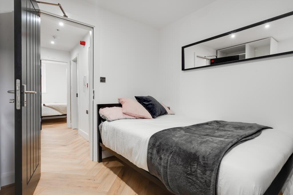 A bright and modern master bedroom featuring a ...