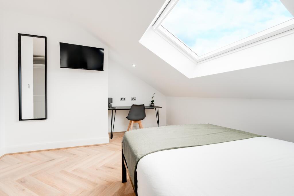 A bright and clean bedroom with a contemporary ...