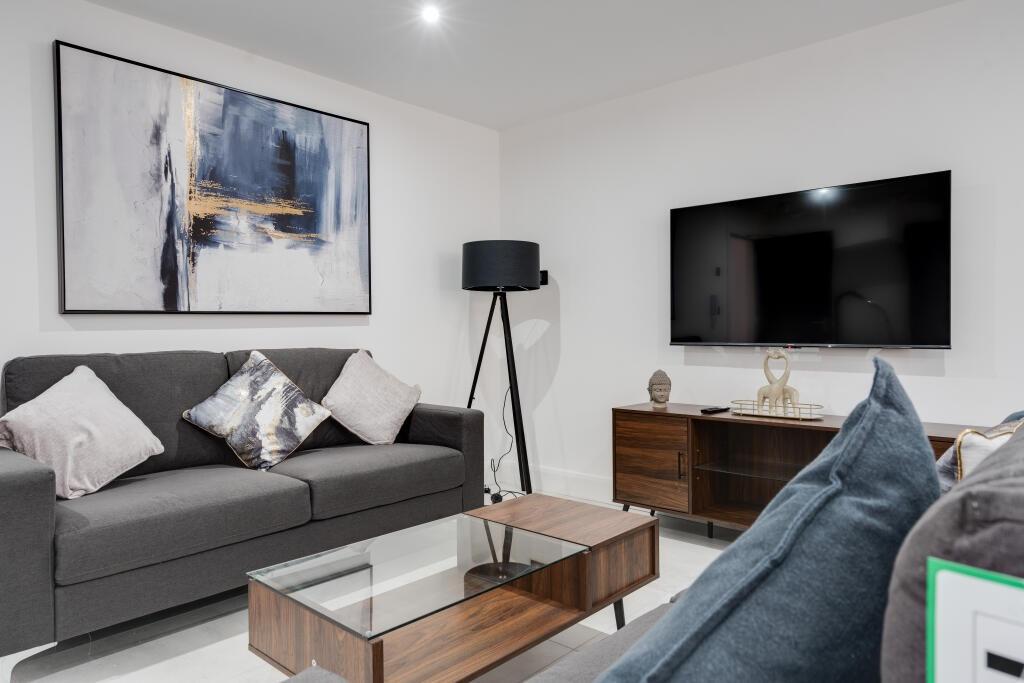 A modern and well-lit living room featuring a l...