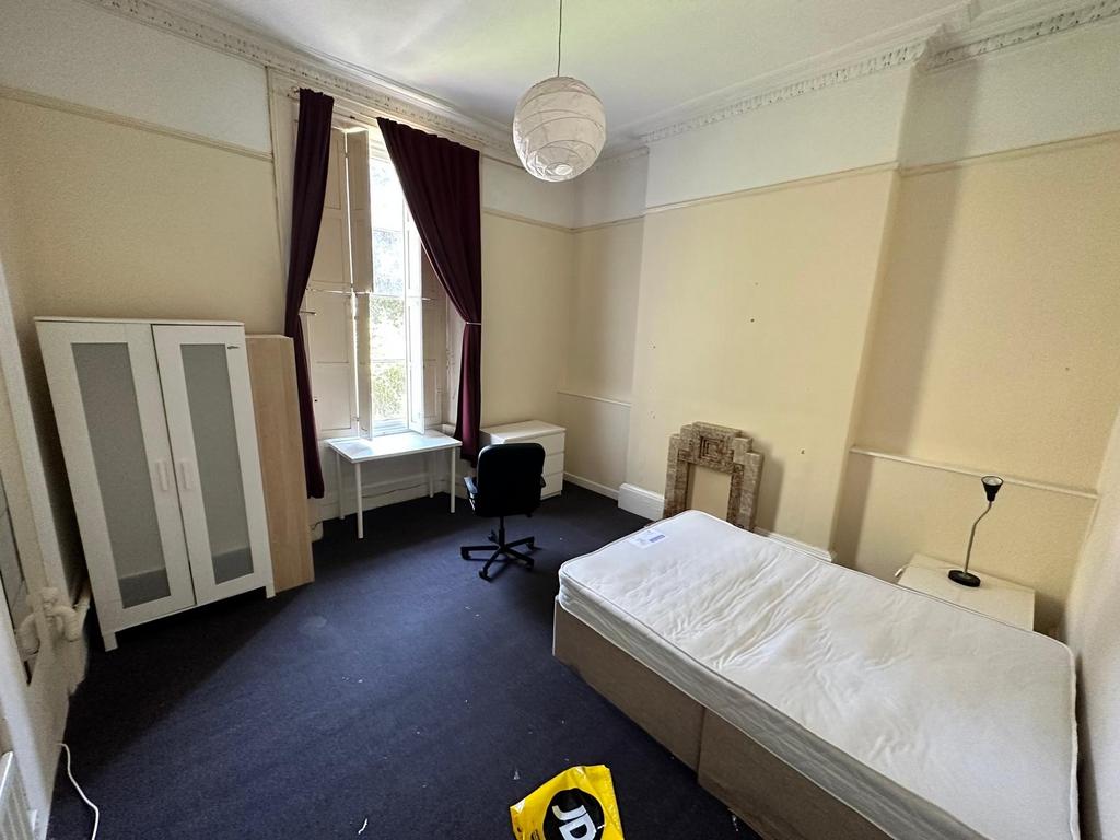 Bright single bedroom with high ceilings, tall ...