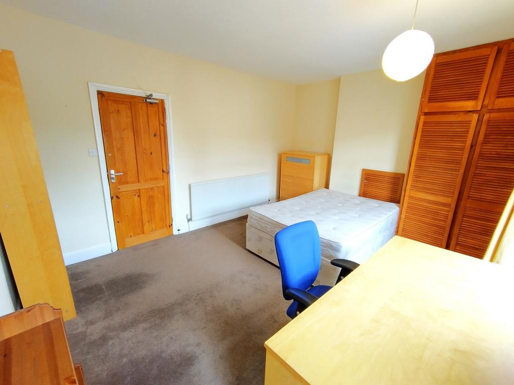 Bright, neutrally decorated double bedroom with...