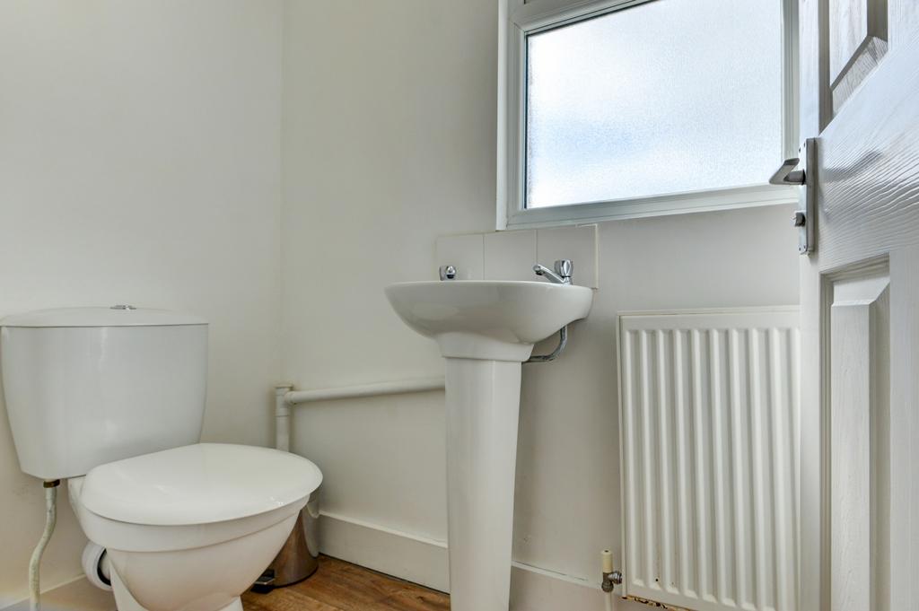 A bright and tidy bathroom featuring a standard...