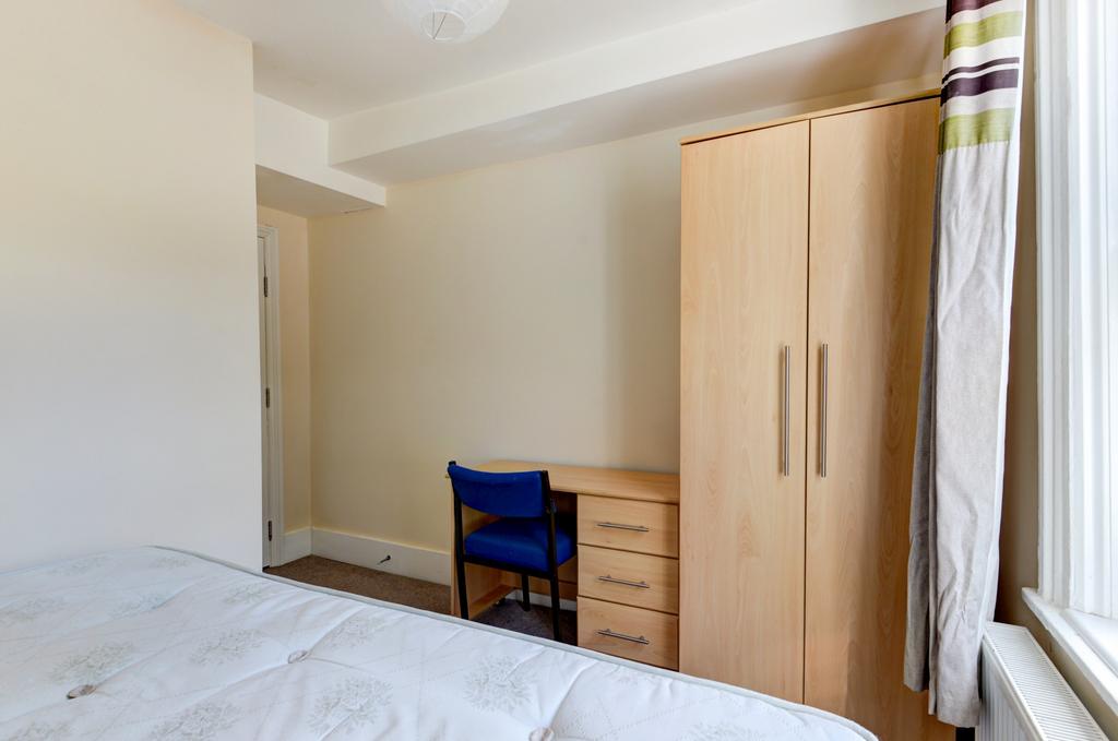 Bright, tidy bedroom with a comfortable bed, fu...