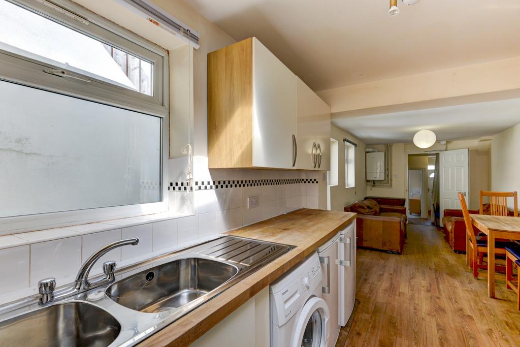 Bright galley-style kitchen with a twin-bowl si...