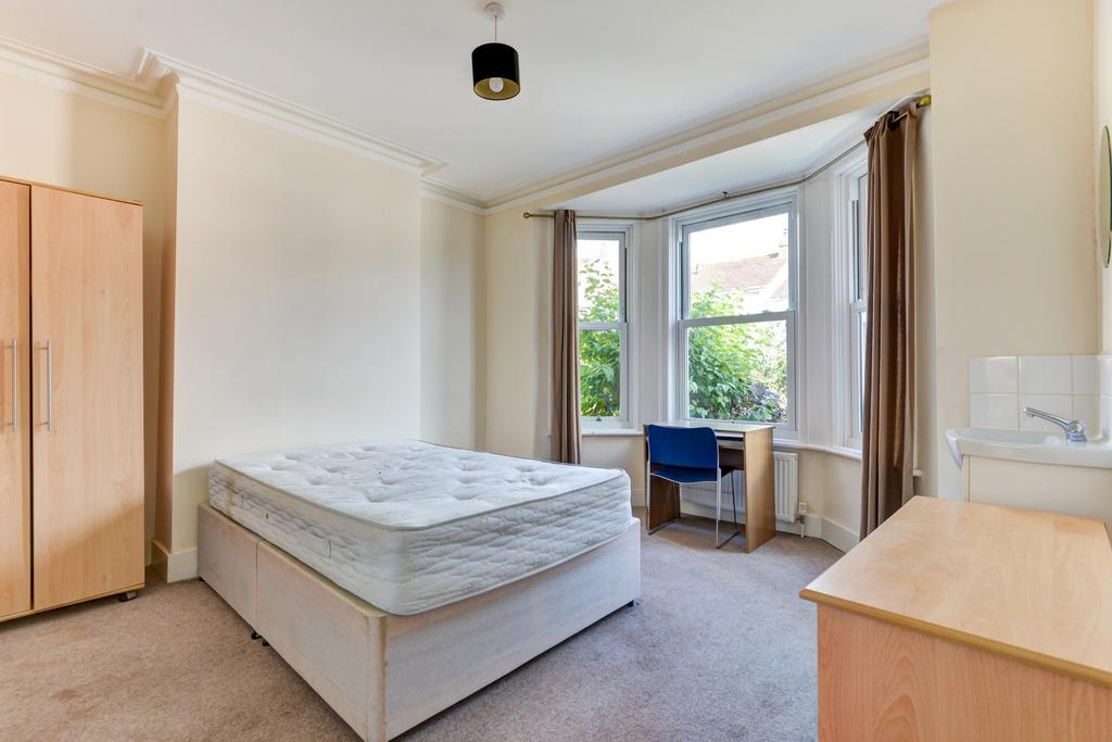 Bright and welcoming bedroom with a large windo...