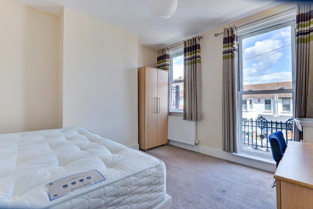 A bright and spacious living room with large wi...