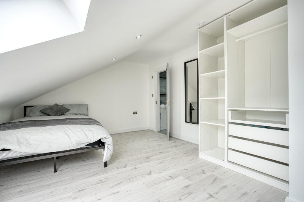 A bright and modern bedroom featuring a minimal...
