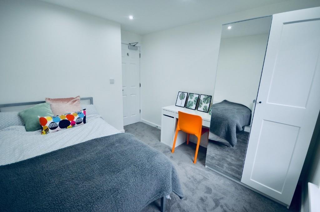 A well-maintained bedroom featuring a double be...
